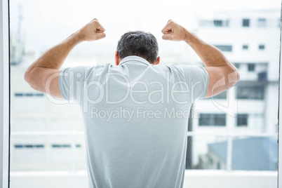 Tensed man leaning on glass window