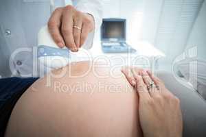 Pregnant woman receiving ultrasound treatment