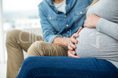 Man holding pregnant womans stomach