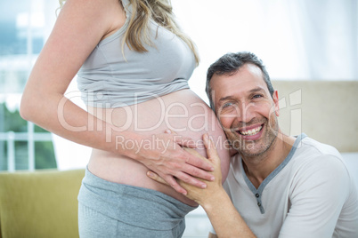 Man listening to pregnant womans stomach