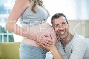 Man listening to pregnant womans stomach