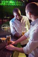 Two men having beer at bar