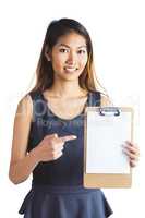 Smiling businesswoman pointing a clipboard