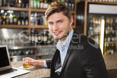 Handsome man having a drink