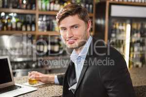 Handsome man having a drink