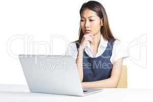 Doubtful businesswoman using a laptop