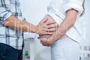 Man touching pregnant womans belly