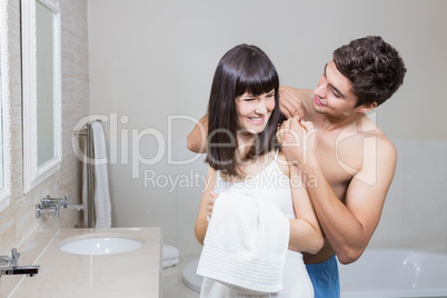 Man applying moisturizer on womans back