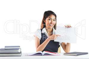 Smiling businesswoman pointing a sheet of paper