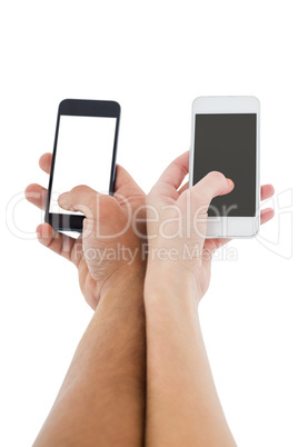 Hands of a couple holding smartphones