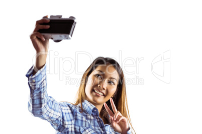 Smiling asian woman taking picture with camera