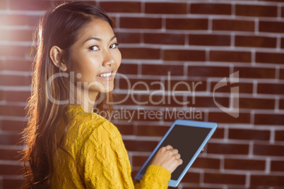 Smiling asian woman using tablet