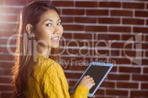 Smiling asian woman using tablet