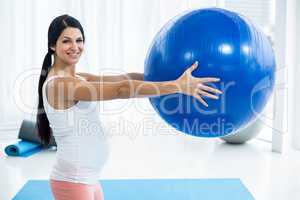 Pregnant woman exercising with exercise ball