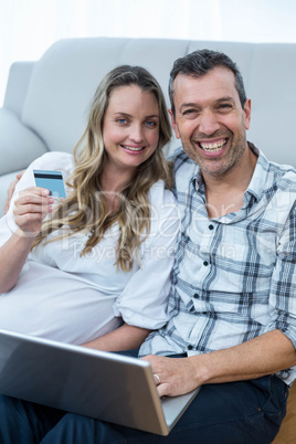 Expecting couple sitting on floor