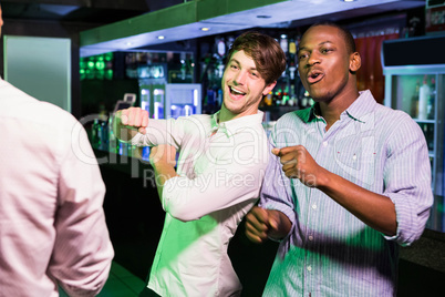 Group of men dancing near bar counter