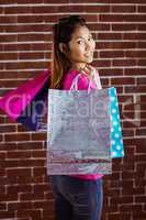 Smiling asian woman with shopping bags