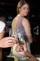 Couple toasting champagne glasses while unhappy looking at them