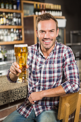 Handsome man having a beer