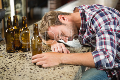 Exhausted man leaning his head on the counter