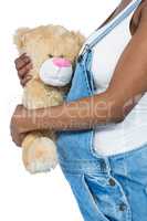 Pregnant woman holding a teddy bear