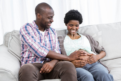 Man touching pregnant womans stomach