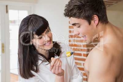 Woman feeding fruits to man