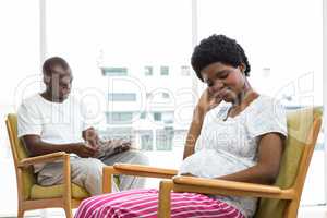 Pregnant couple sitting on chair