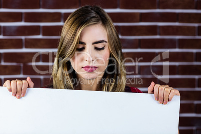 Pretty blonde woman holding a white sign