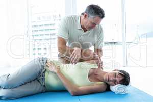 Physiotherapist giving physiotherapy to pregnant woman