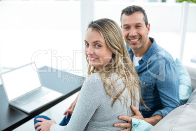 Couple using laptop in living room