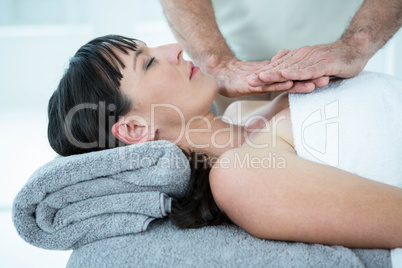 Pregnant woman receiving a massage from masseur