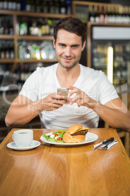 Handsome man taking a picture of his food