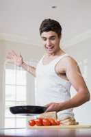 Young man cooking food in kitchen