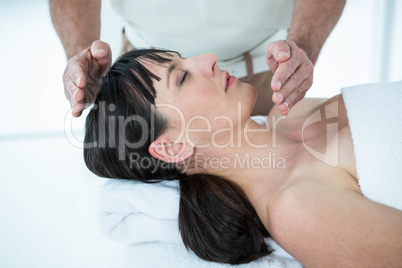 Pregnant woman receiving a massage from masseur