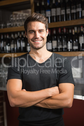 Handsome bar tender standing behind his counter