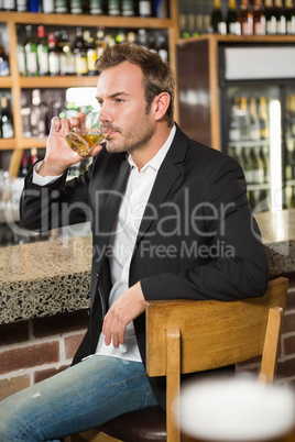Handsome man having a whiskey