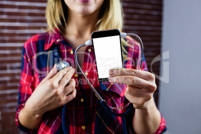 Pretty blonde woman showing smartphone screen