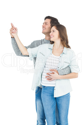 Couple embracing and pointing up