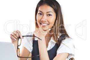 Smiling businesswoman holding her chin and her eyeglasses