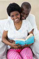 Pregnant couple reading a book