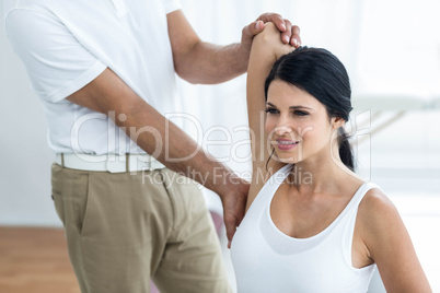 Doctor giving physiotherapy to pregnant woman
