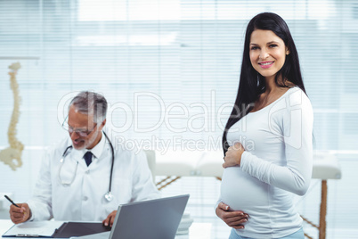 Pregnant woman with doctor at clinic