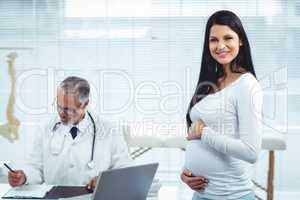 Pregnant woman with doctor at clinic