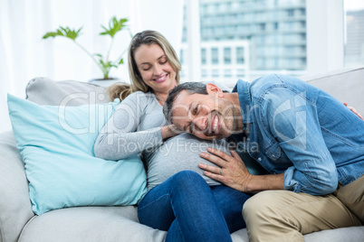 Man listening to pregnant womans stomach