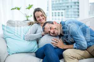 Man listening to pregnant womans stomach