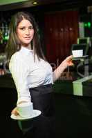 Portrait of pretty waitress serving coffee