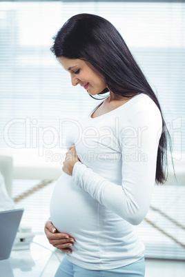 Pregnant woman holding her stomach