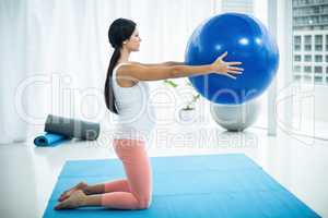 Pregnant woman exercising with exercise ball