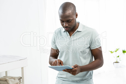 Thoughtful man using a digital tablet